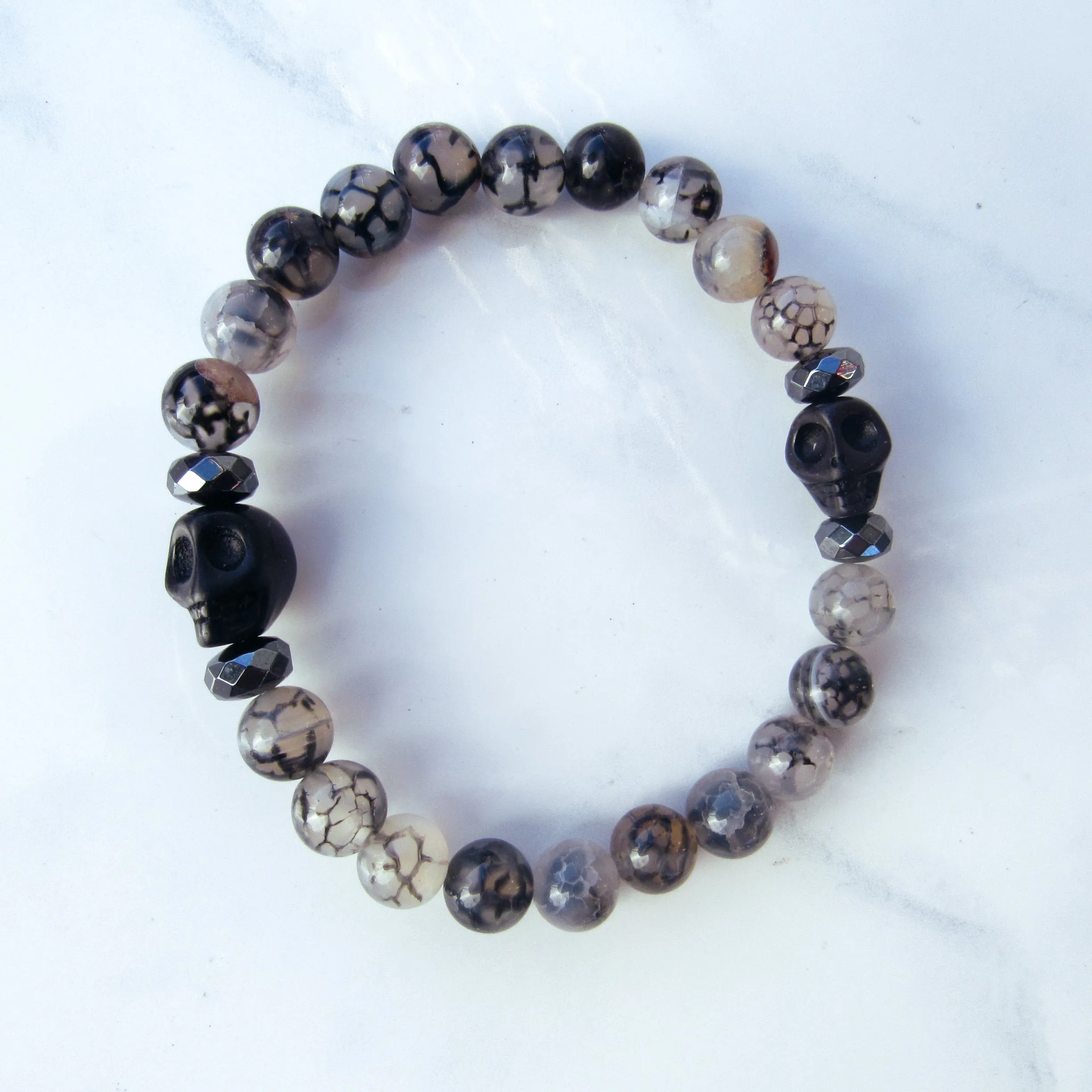 Howlite Skulls, Hematite, Dragon’s Vein Agate gemstone Stretch Bracelet