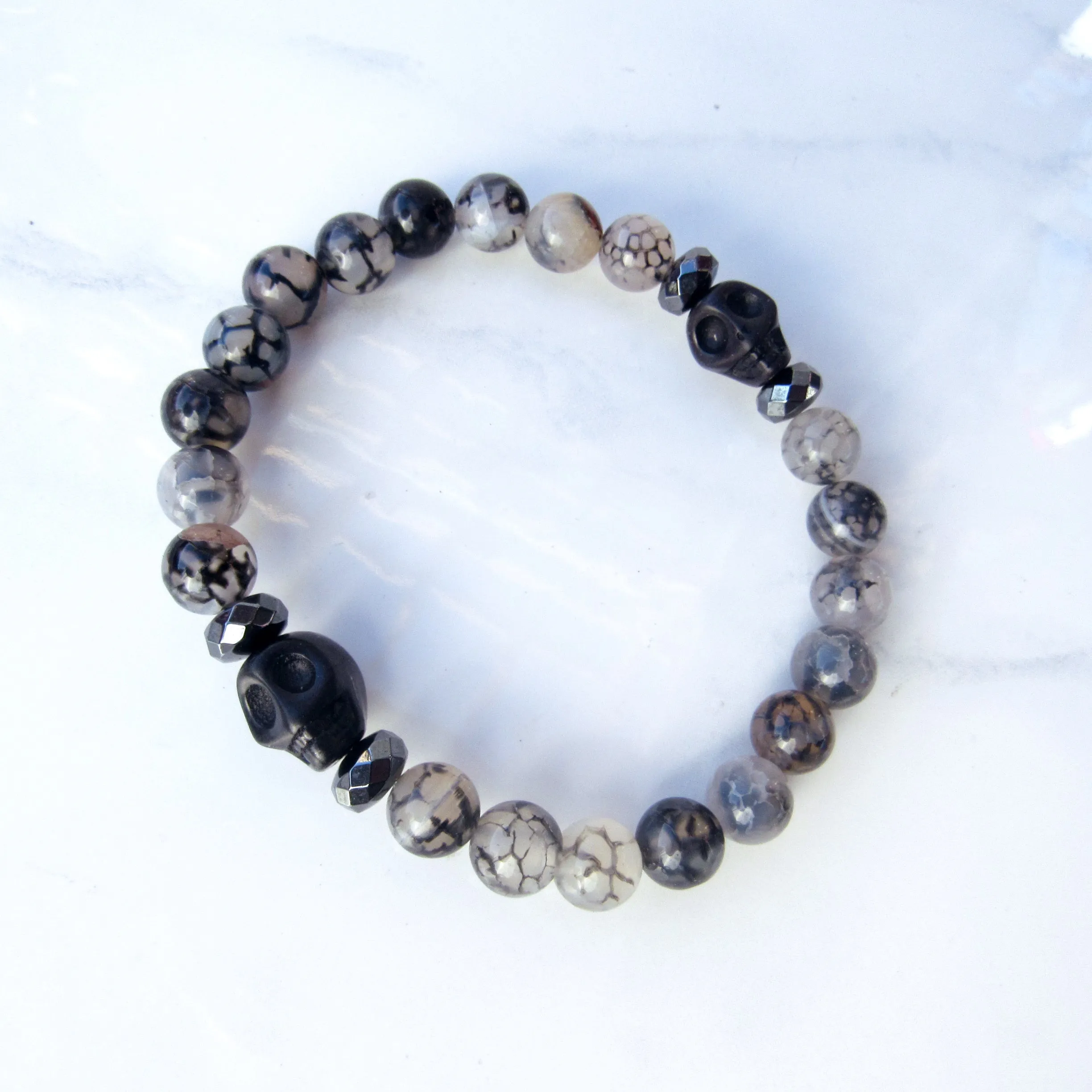 Howlite Skulls, Hematite, Dragon’s Vein Agate gemstone Stretch Bracelet