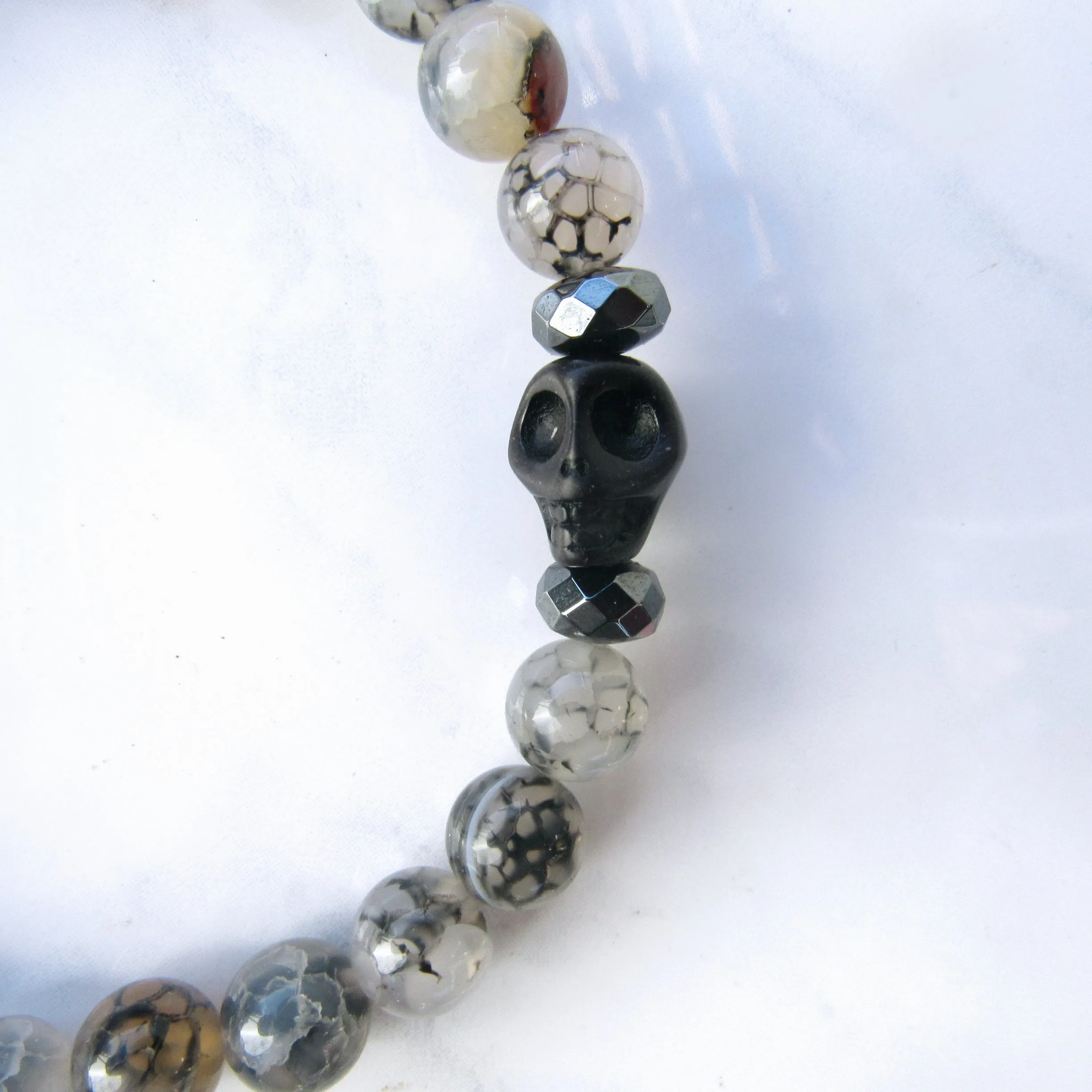 Howlite Skulls, Hematite, Dragon’s Vein Agate gemstone Stretch Bracelet